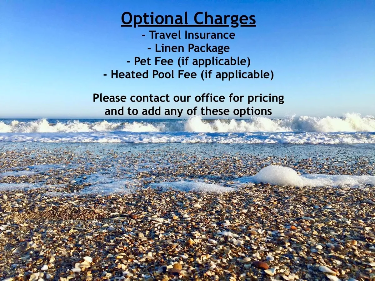 A picturesque sandy beach with gentle waves rolling in under a clear blue sky. The tranquil shoreline invites visitors for walks, sunbathing, or simply enjoying the soothing sound of the ocean.